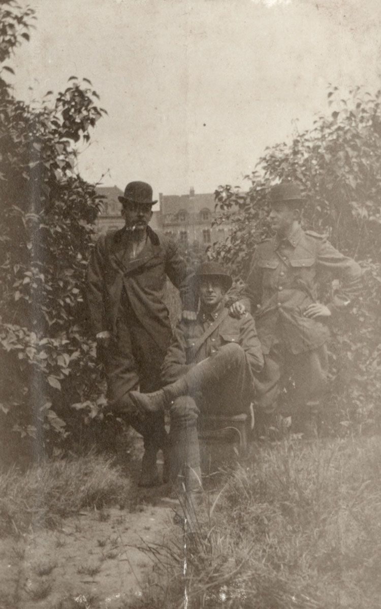 Three soldiers don bowler hats at Armentières. 1916.